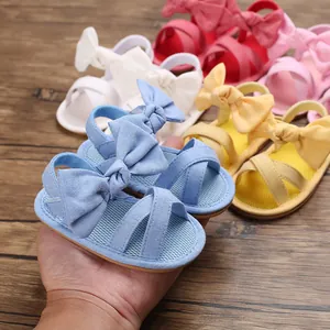Close-up detail of soft cotton baby walking sandals featuring a large decorative bow knot