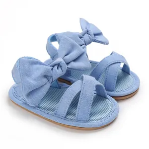 Detailed side view of light blue baby girl sandals featuring a large decorative bow knot