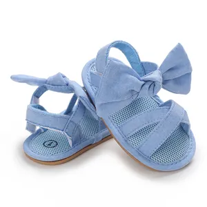 Detailed view of light blue infant baby girl sandals with large bow and mesh insole
