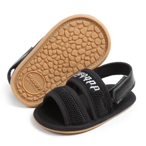 Close-up detail of breathable black mesh baby sandals with soft anti-slip rubber soles.