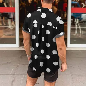 Back view of men's black short sleeve shirt with large white polka dot print for summer