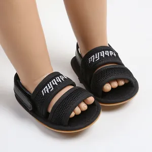 Detailed view of breathable black mesh baby sandals with soft soles on infant feet