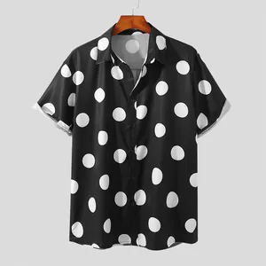 Front view of black short-sleeve button-up shirt featuring large white polka dots