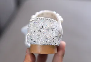 Detailed view of children's princess shoe heel with rhinestones and pearls