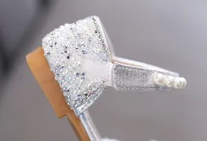 Detailed view of silver girls princess dress shoes featuring elegant pearls and sparkling rhinestones