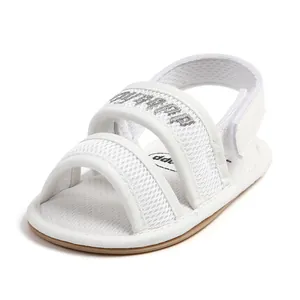 Detailed view of white breathable mesh baby walking sandals with soft soles and velcro.