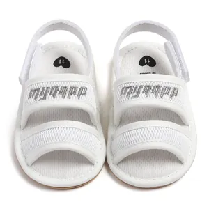 Top-down view of white mesh baby sandals featuring dual adjustable straps