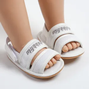 Close-up detail of white mesh baby sandals with soft soles for spring and summer
