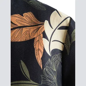 Close-up of tropical leaf print on black men's casual cotton shirt detail