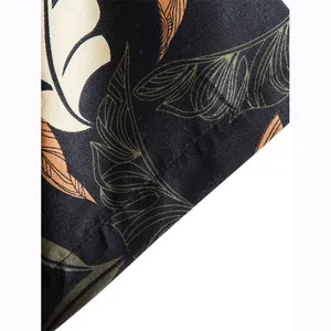 Close-up of tropical leaf print on black cotton men's short sleeve shirt