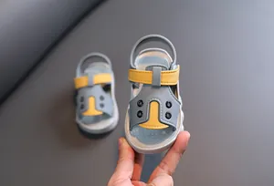 Detailed view of blue and yellow toddler walking sandals with non-slip soft sole for summer