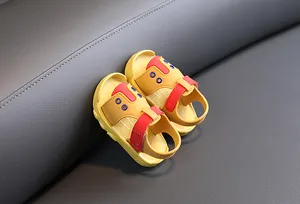 Detailed macro view of yellow baby summer walking sandals with anti-slip soft soles