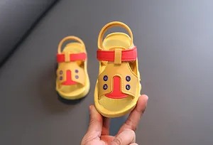 Detailed view of yellow baby summer sandals with soft anti-slip soles for toddlers