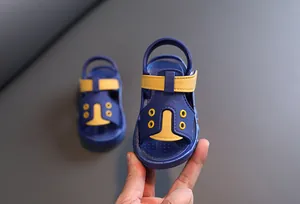 Detail view showing the soft texture of blue and yellow baby sandals for toddlers