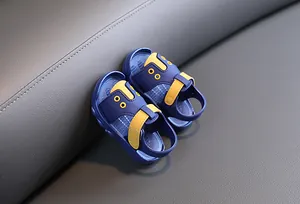Close-up detail of blue and yellow baby summer sandals with non-slip soft soles