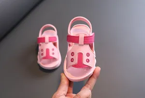Detailed view of pink baby sandals with soft soles and velcro straps for toddlers