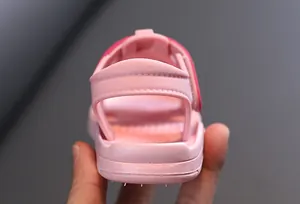 Close-up detail showing the soft heel strap and non-slip sole of a pink baby sandal