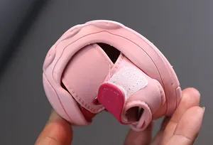 Close-up showing the extreme flexibility of the soft pink baby sandal sole.