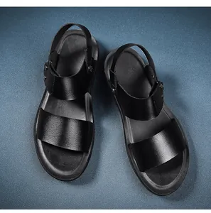 Top-down view of premium black leather men's sandals on blue textured background