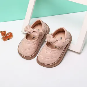 Detailed view of pink toddler princess shoes featuring heart stitching and a cute bow
