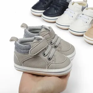 Close-up view of grey baby walker shoes with pebble leather texture and velcro strap