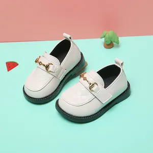 Close-up of white girls' loafers with woven toe and gold horsebit detail