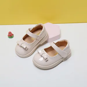 Elegant beige patent leather baby girl Mary Jane shoes with bow detail and soft sole