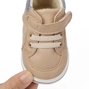 Detailed close-up of beige infant pre-walker shoe with soft sole and velcro strap