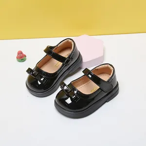 Classic black patent leather baby girl princess shoes with cute bow detail and soft soles