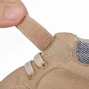 Close-up of beige baby pre-walker shoe showing the velcro strap closure detail