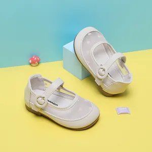 Detailed view of cream baby girl Mary Jane shoes with heart pattern mesh and buckle strap