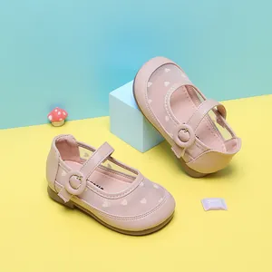 Detail of pink toddler girl shoes featuring heart-patterned mesh and round buckle strap.