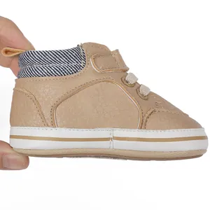 Detailed side view of beige baby boy pre-walker shoes with striped fabric collar