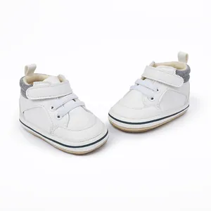 Detailed view of white baby pre-walker sneakers with velcro strap and striped heel