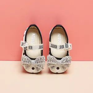 Detailed view of toddler girl's polka dot princess shoes featuring a luxury rhinestone bow