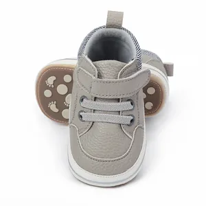 Close-up of grey textured baby pre-walker shoes with soft anti-slip soles
