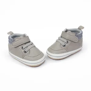 Detail view of gray infant boy soft sole walker shoes with secure velcro straps and striped collar