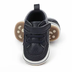 Front view of dark blue faux leather baby boy walking shoes with hook-and-loop strap