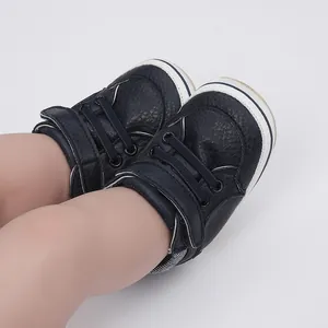 Detailed close-up of navy blue faux leather baby pre-walker shoes with velcro strap
