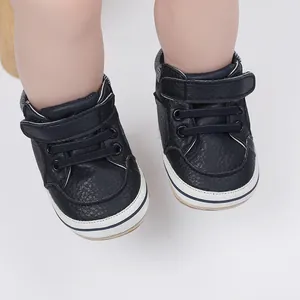 Detail of navy blue baby first walker shoes with Velcro strap and soft rubber sole