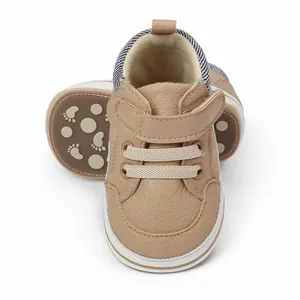 Close-up of beige soft-sole baby walking shoes featuring velcro straps and non-slip soles