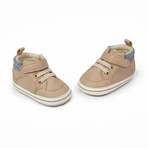 Classic brown infant walker shoes featuring striped collar and velcro strap detail