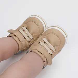 Close-up of khaki baby boy pre-walker shoes with leather texture and velcro strap