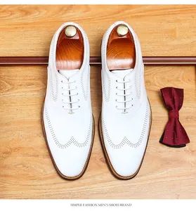 Premium white leather men's brogue shoes featuring elegant decorative perforation detail