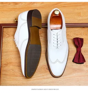 Premium white leather men's brogue dress shoes showing detailed top and sole view