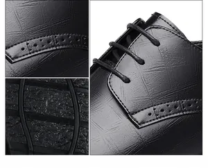 Macro view of black business elevator shoes showing textured leather and stitching detail