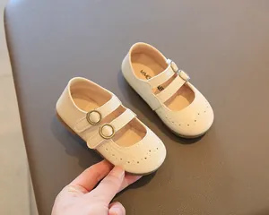 Detailed view of beige children's British style Mary Jane shoes with double buckles