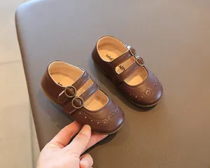 Close-up detail of brown children's British style Mary Jane shoes with double buckle straps