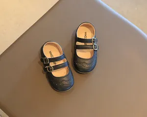 Top-down view of classic black children's Mary Jane shoes with double buckle straps.