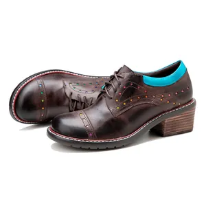 Close-up of handmade leather oxford shoes with colorful star cutouts and block heels